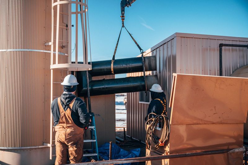 Crane truck lifting equipment on a well site