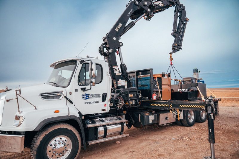 Elite crane truck with the boom extended on location