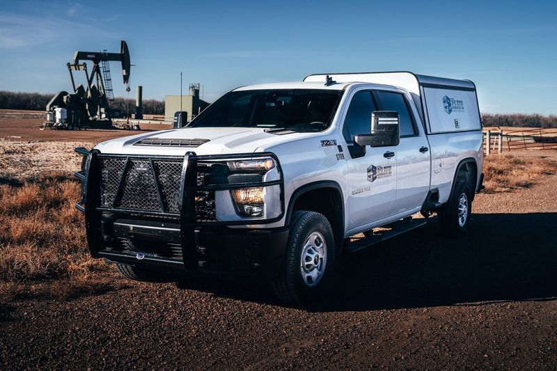 Elite service truck on a lease with pumpjacks behind